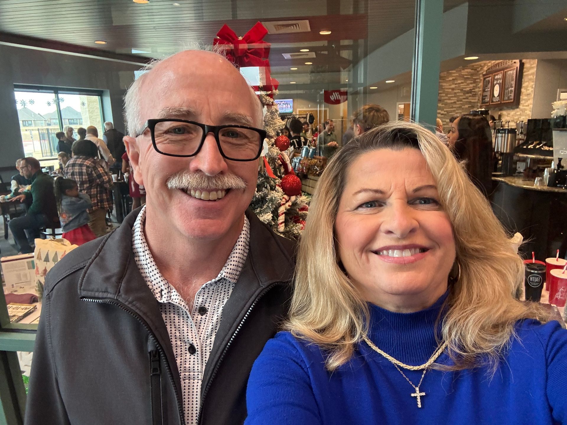 A person inspecting a commercial kitchen hood system, reaching up.