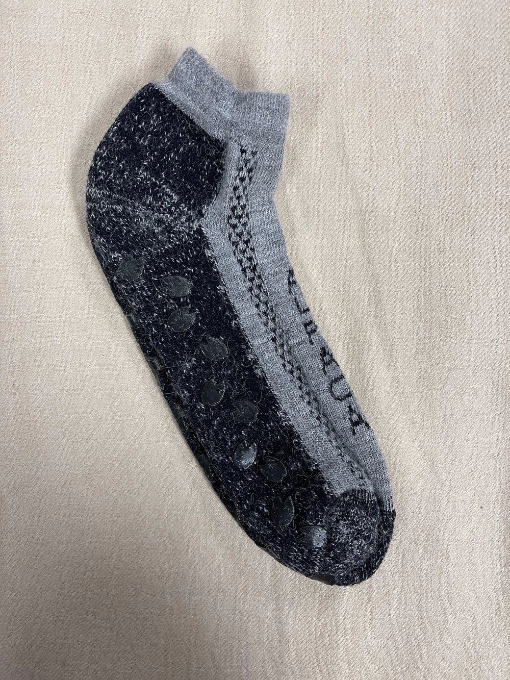 A pair of socks are sitting on a white surface.