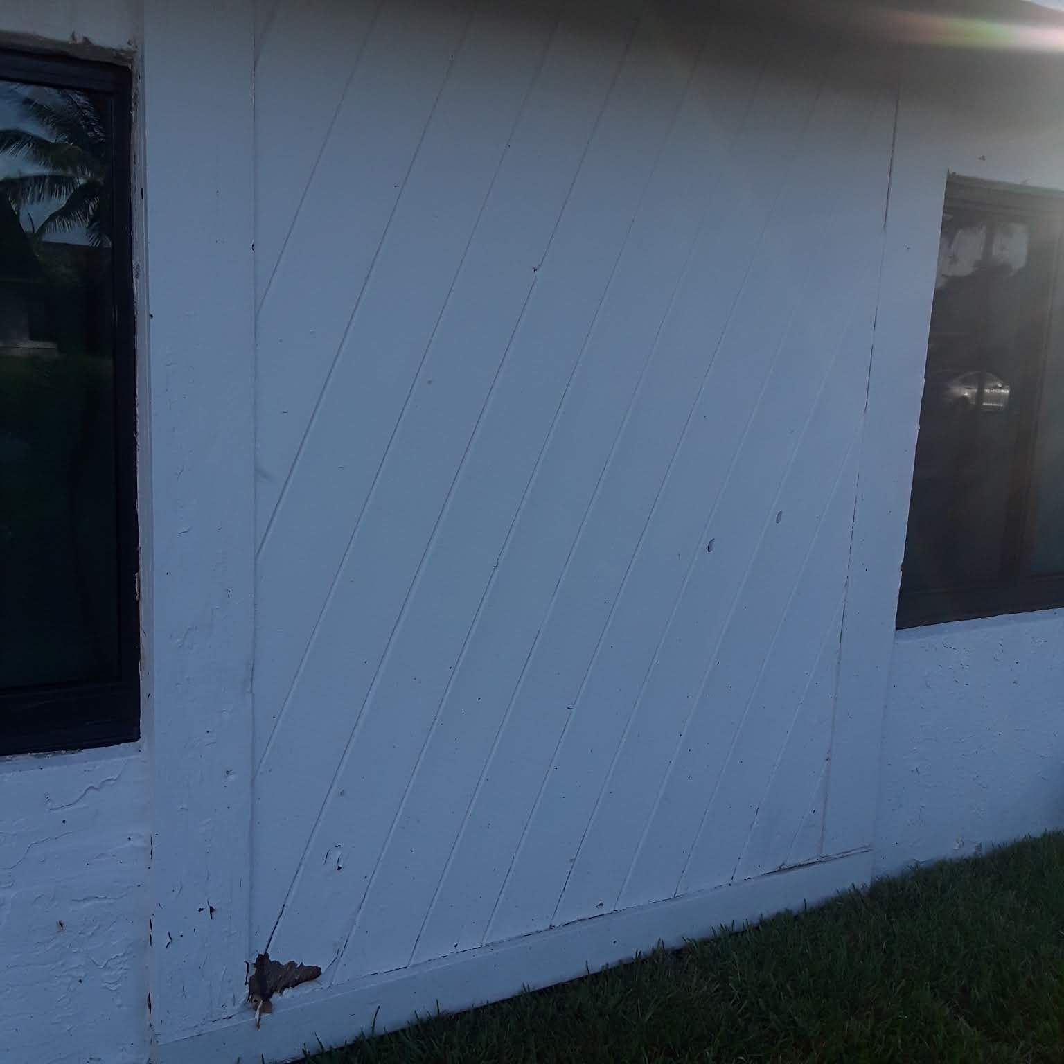 A white building with a window on the side of it.