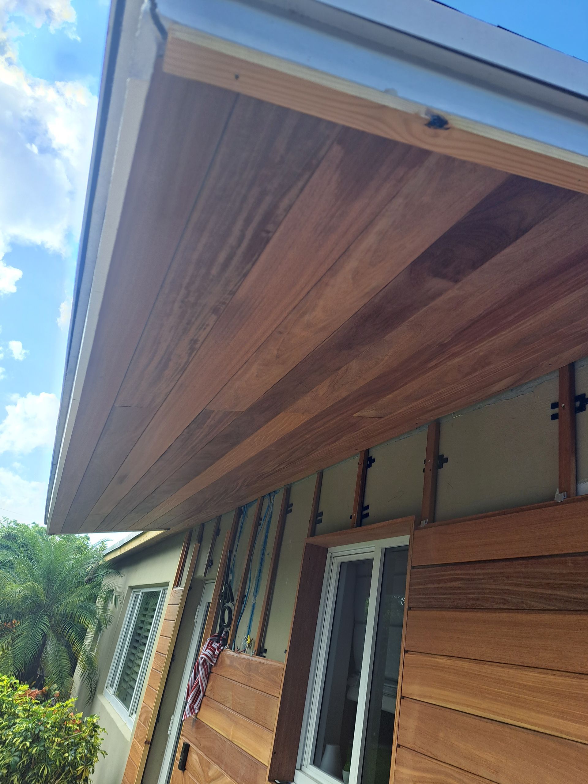 A house with a wooden roof and a wooden door.