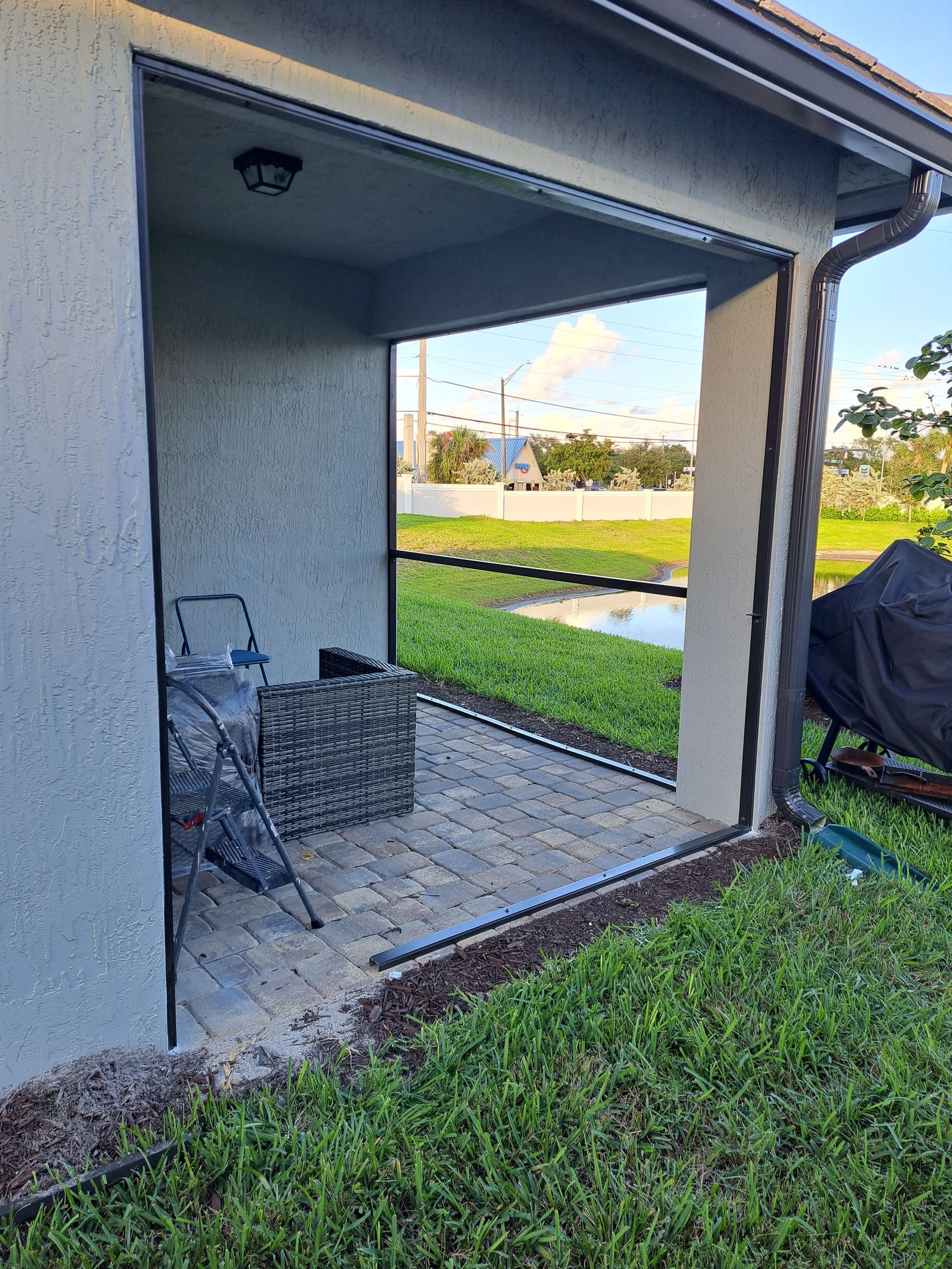 A sliding glass door is being installed on the side of a house.