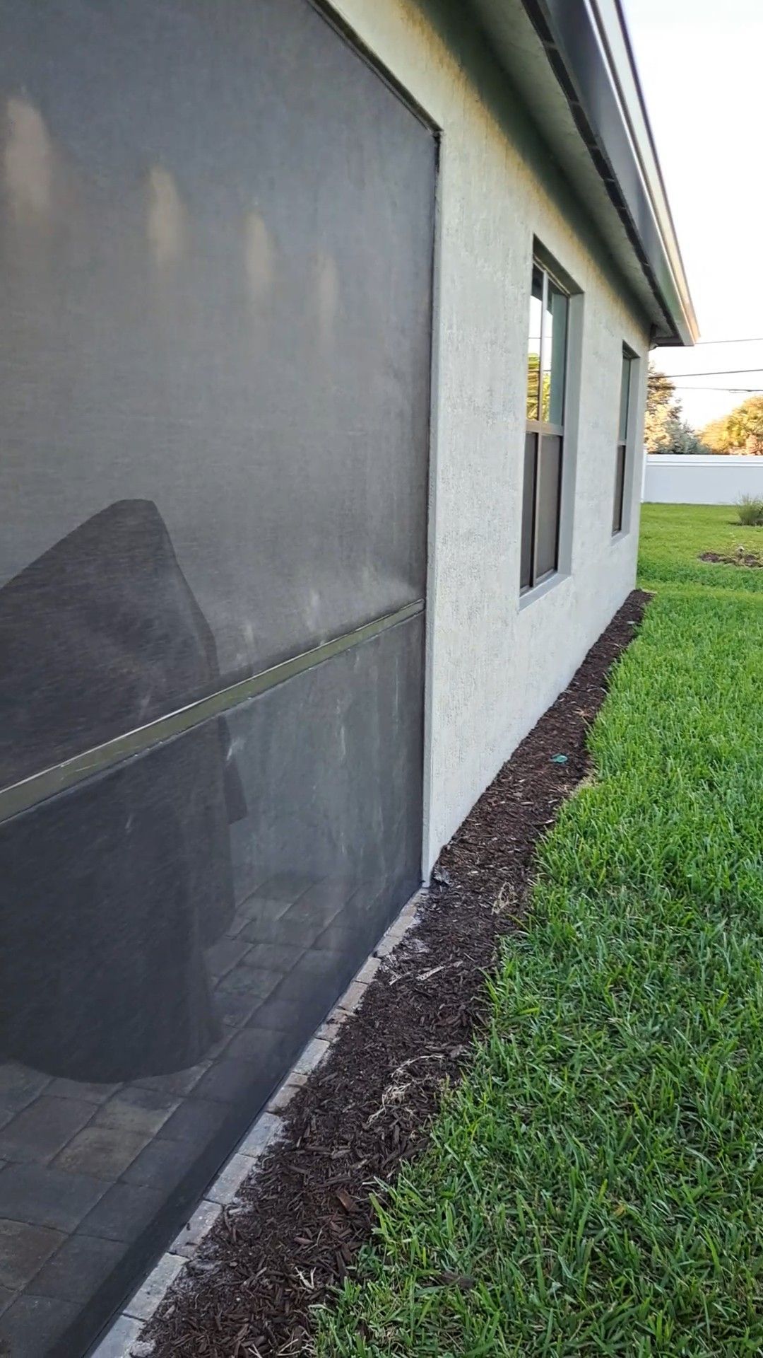 A house with a screen door on the side of it.