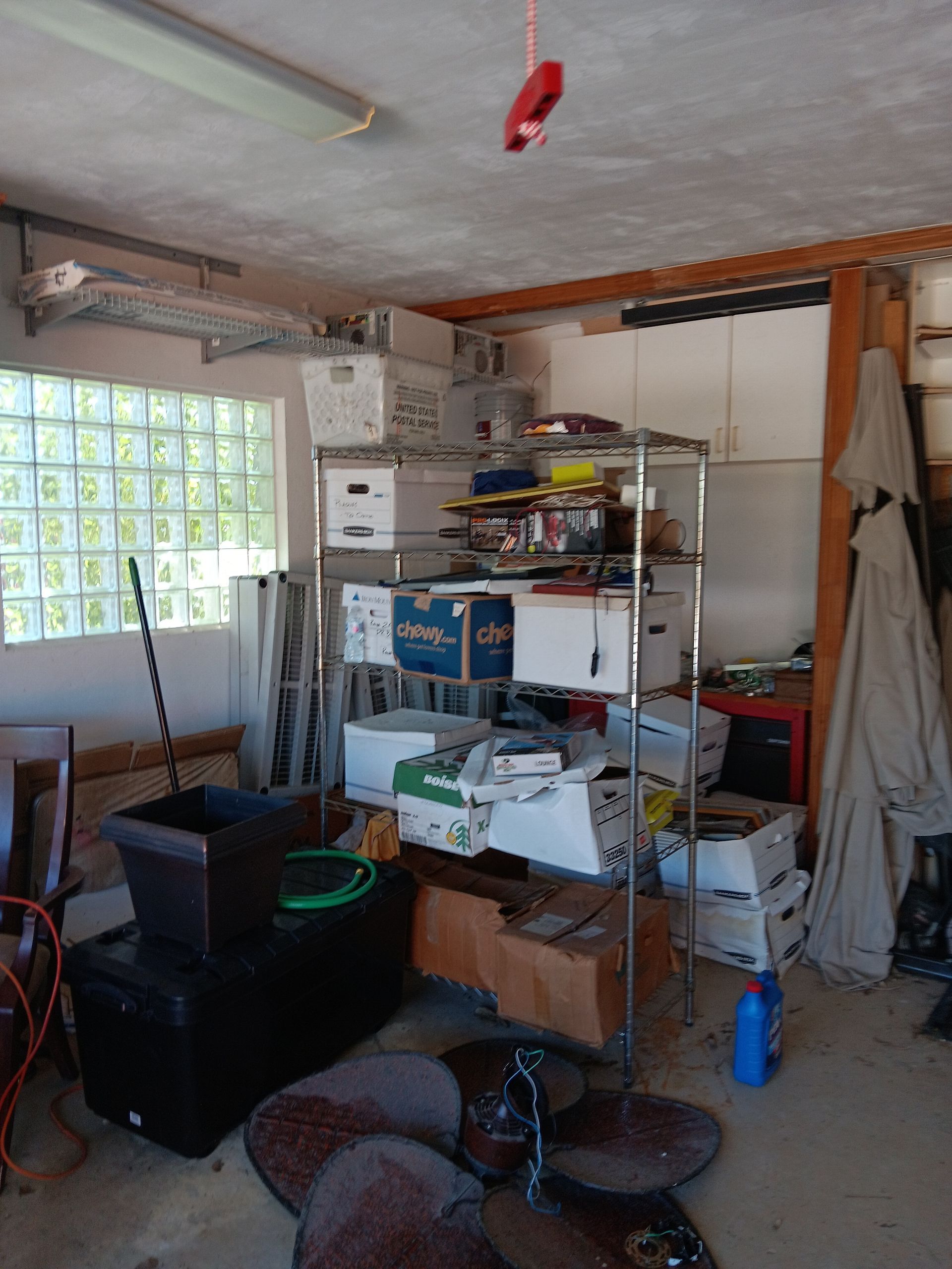 A room with a lot of boxes on shelves and a window