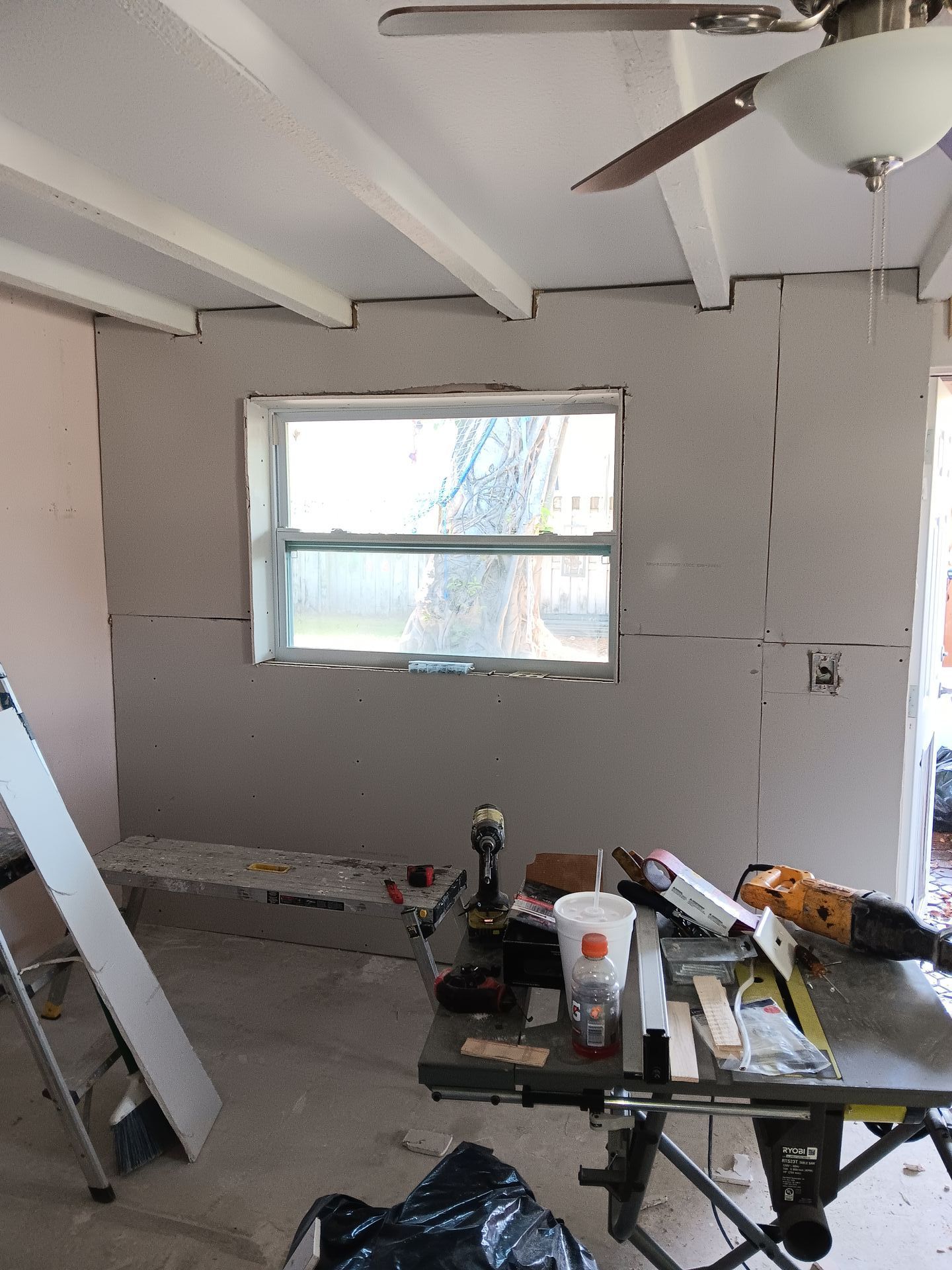 A room with a window and a table with tools on it