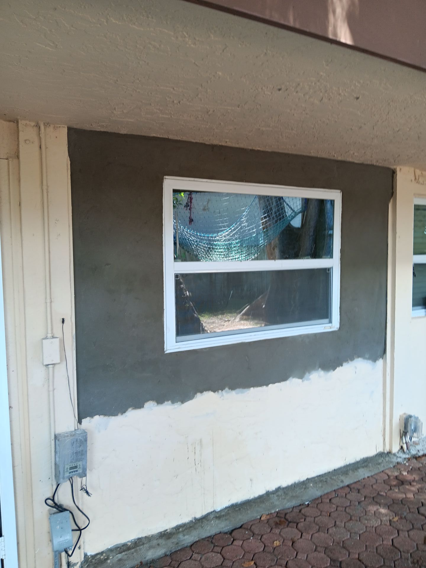 A window is being installed on the side of a building