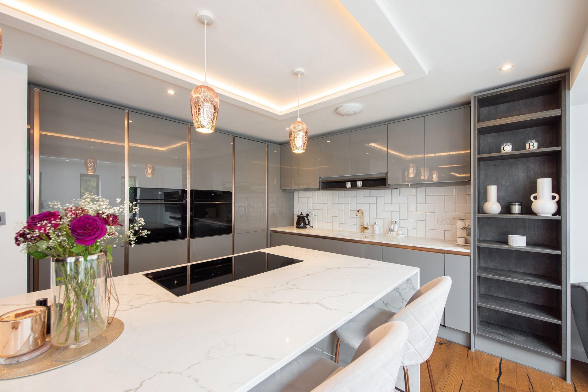 A kitchen with a large island and a stove top oven.