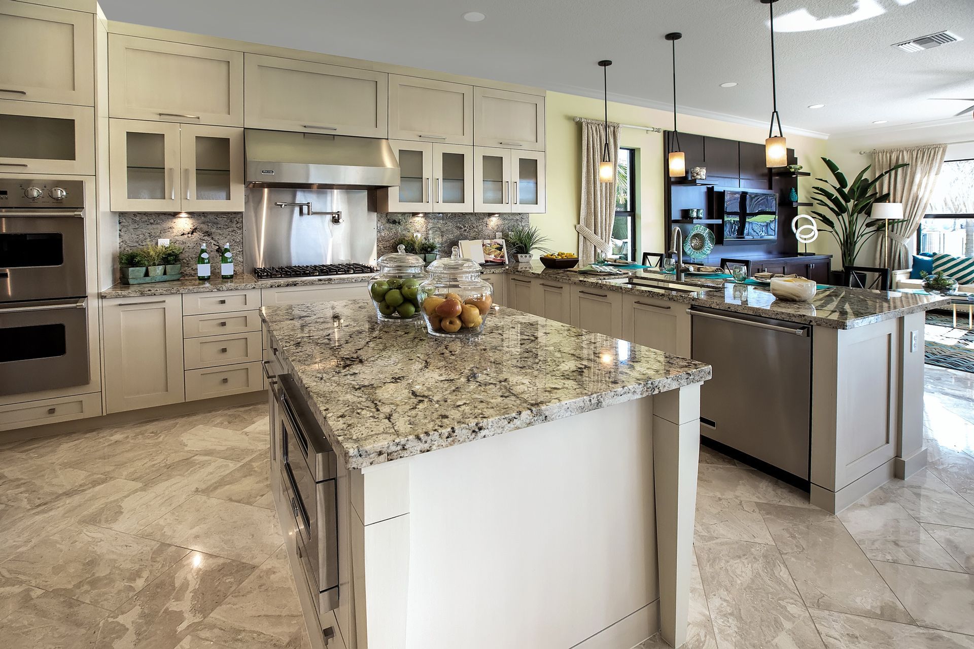 A kitchen with granite counter tops and stainless steel appliances