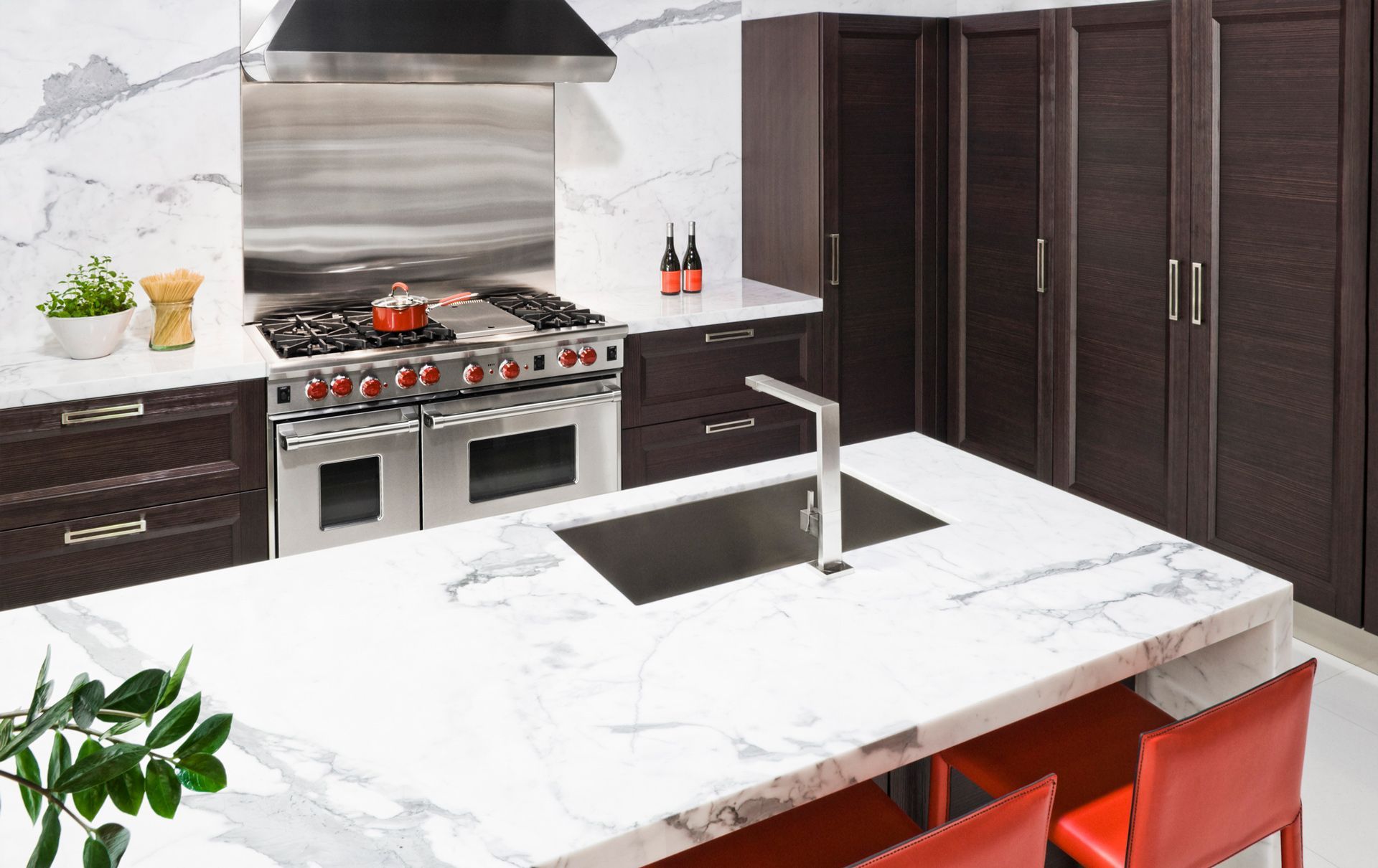 A kitchen with a stove top oven and a sink