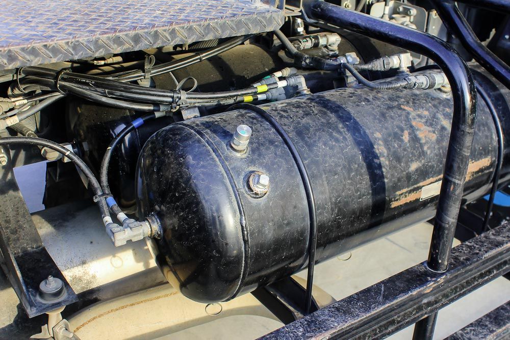 A Black air Tank is Attached to the side of a Truck — Mechanical Servicesin Maroochydore, QLD