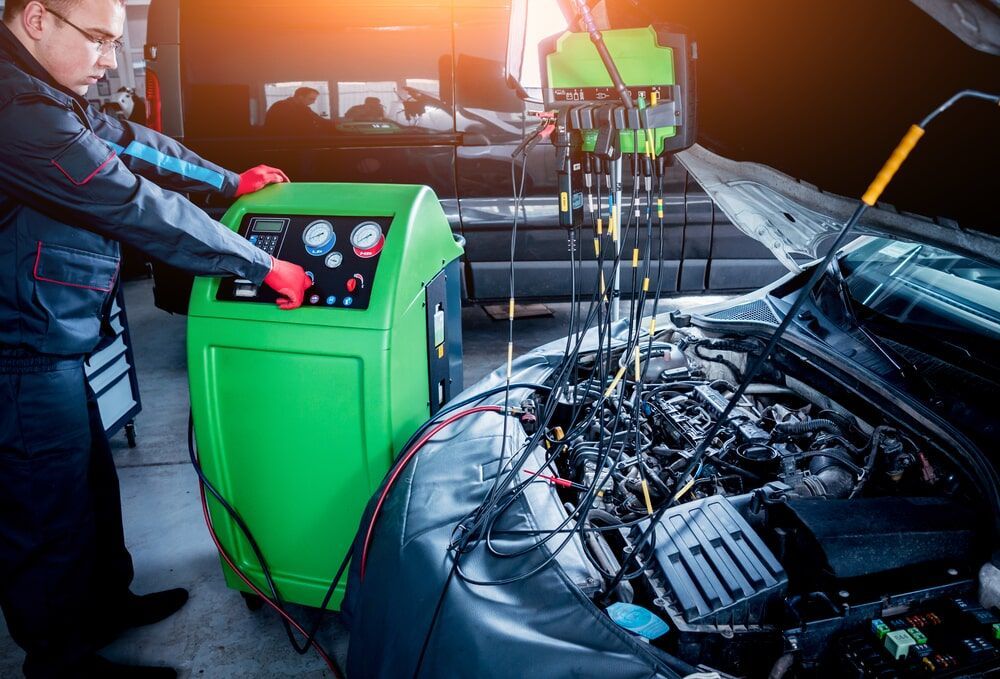 A Man is Working on the Engine of a car in a Garage — Mechanical Services in Maroochydore ,QLD