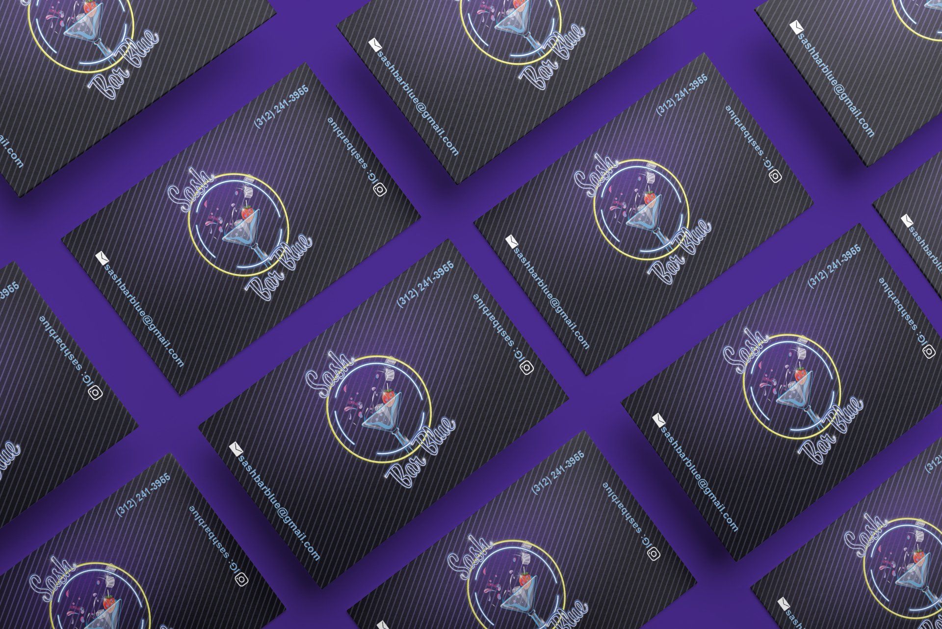 A bunch of business cards are laying on a purple surface.