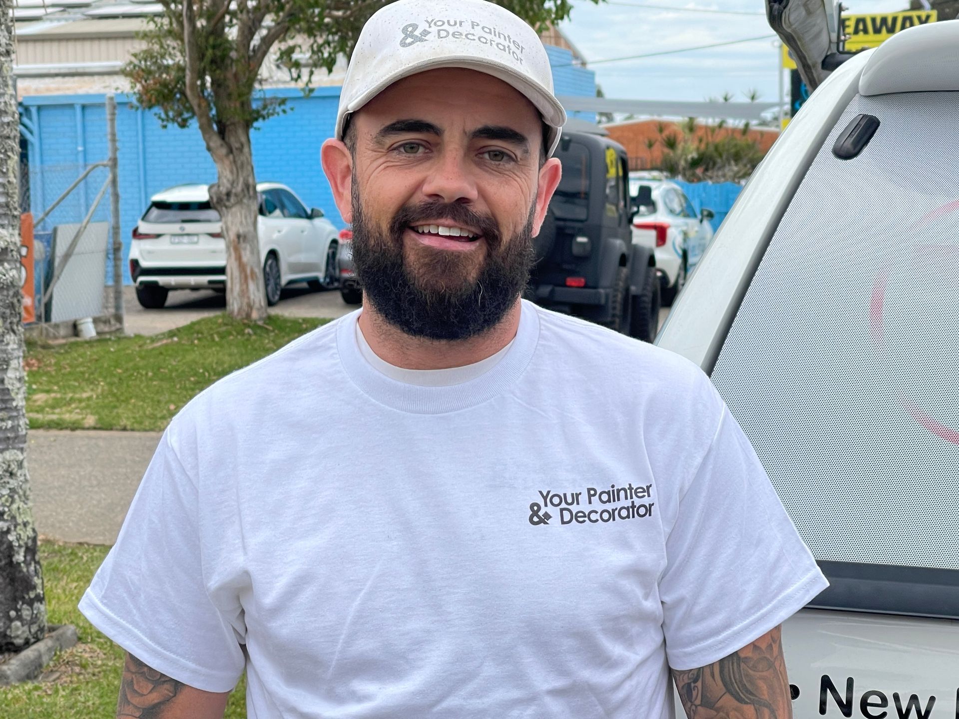 Man in white cap and shirt smiles, in front of a van — Carbon Copy in Port Macquarie, NSW