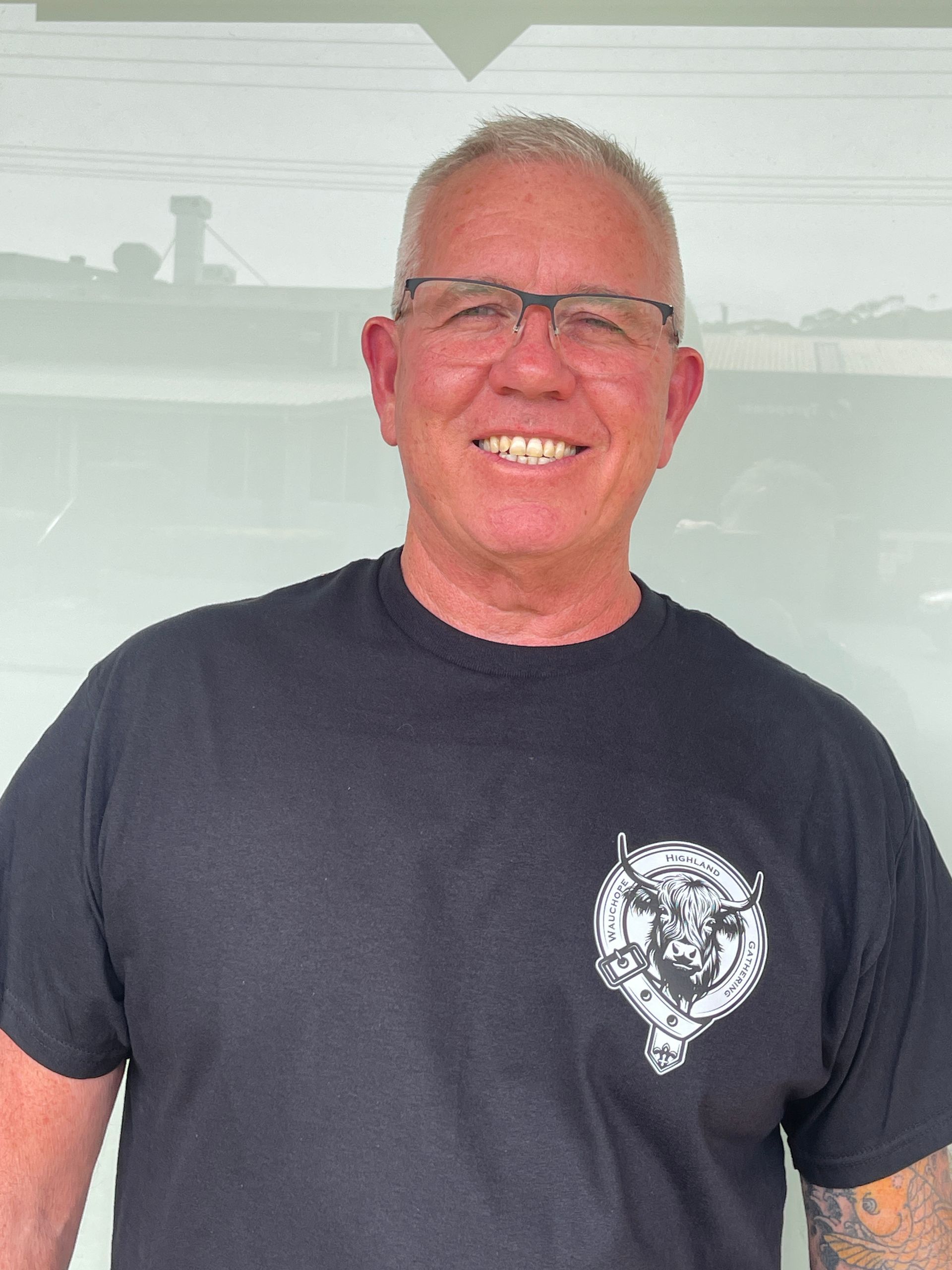 Man wearing glasses and a black t-shirt, smiling — Carbon Copy in Port Macquarie, NSW