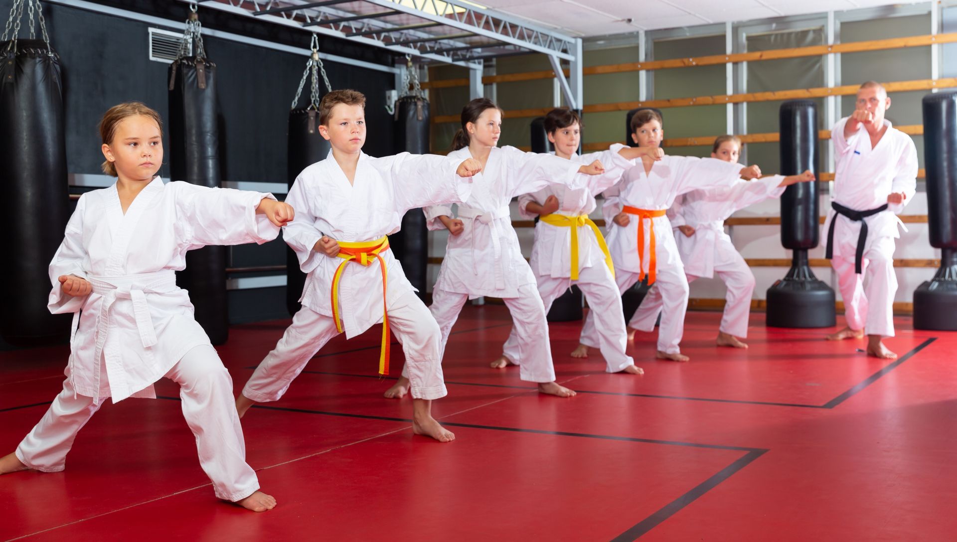 children are practicing karate in a gym