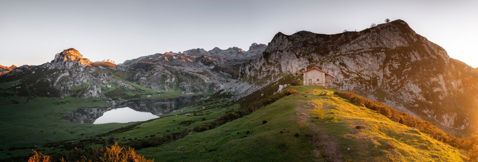 A panoramic view of a mountain range with a lake in the middle.