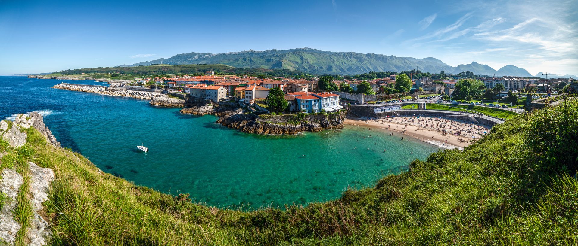 A panoramic view of a small town on a small island in the middle of the ocean.