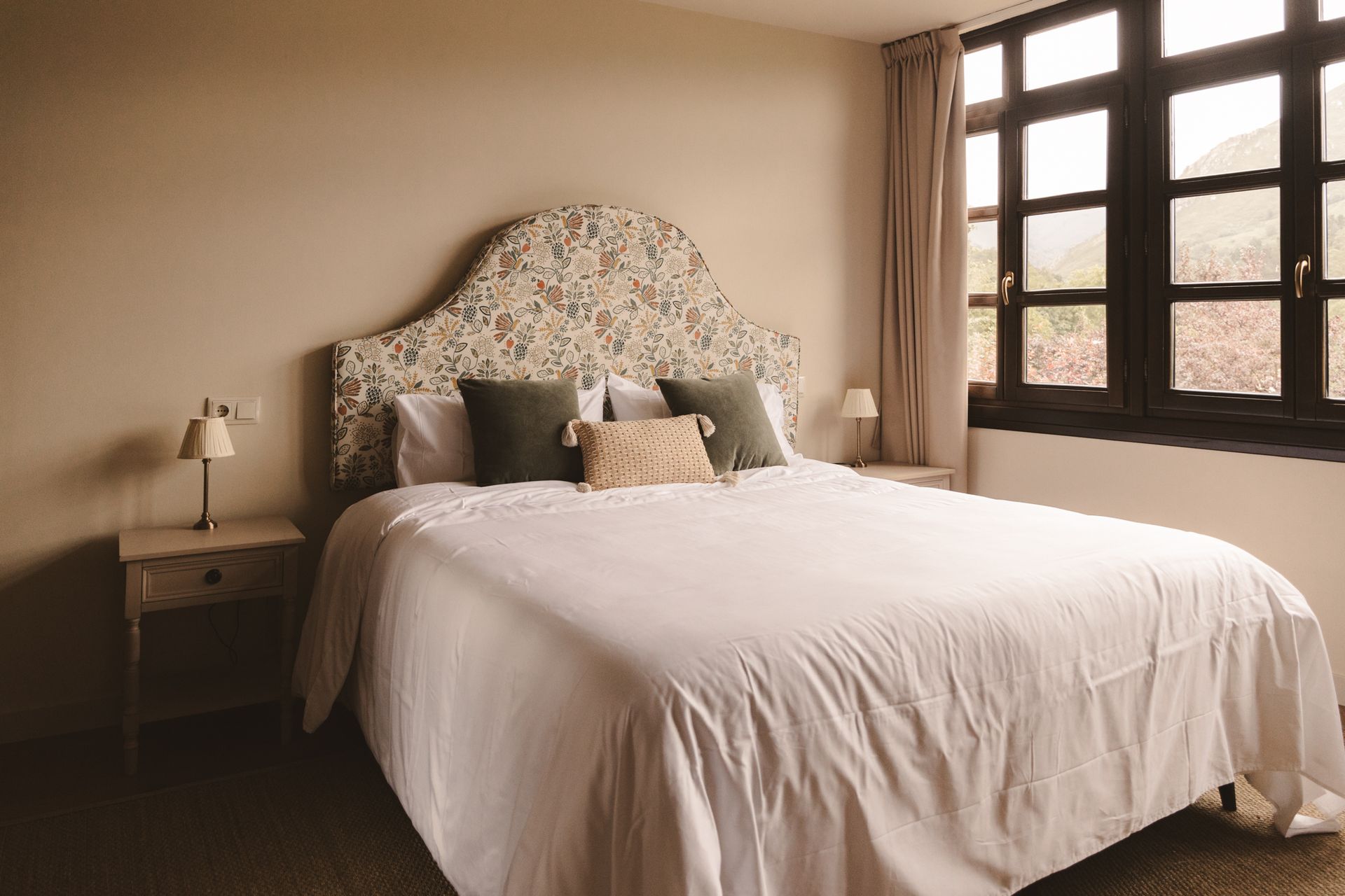 A bedroom with a large bed and a window.