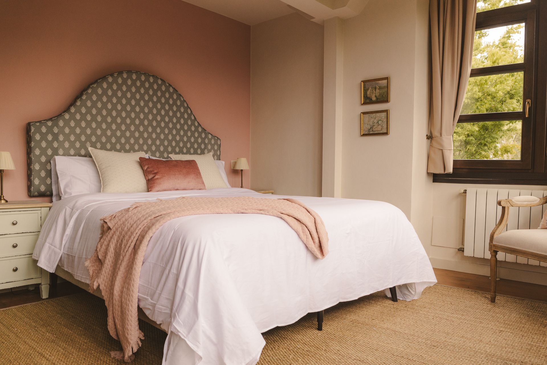 A bedroom with a large bed and a window.