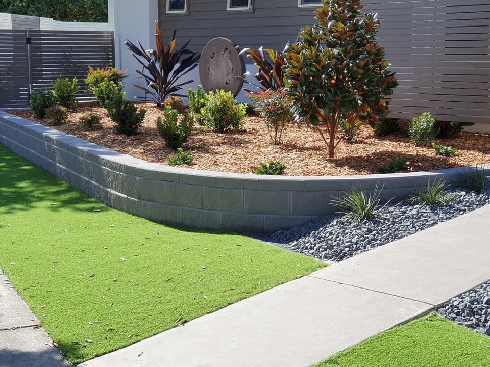 Garden Filled With Rocks , Plants and Steps — Red Dog Landscaping in Banora Point, NSW