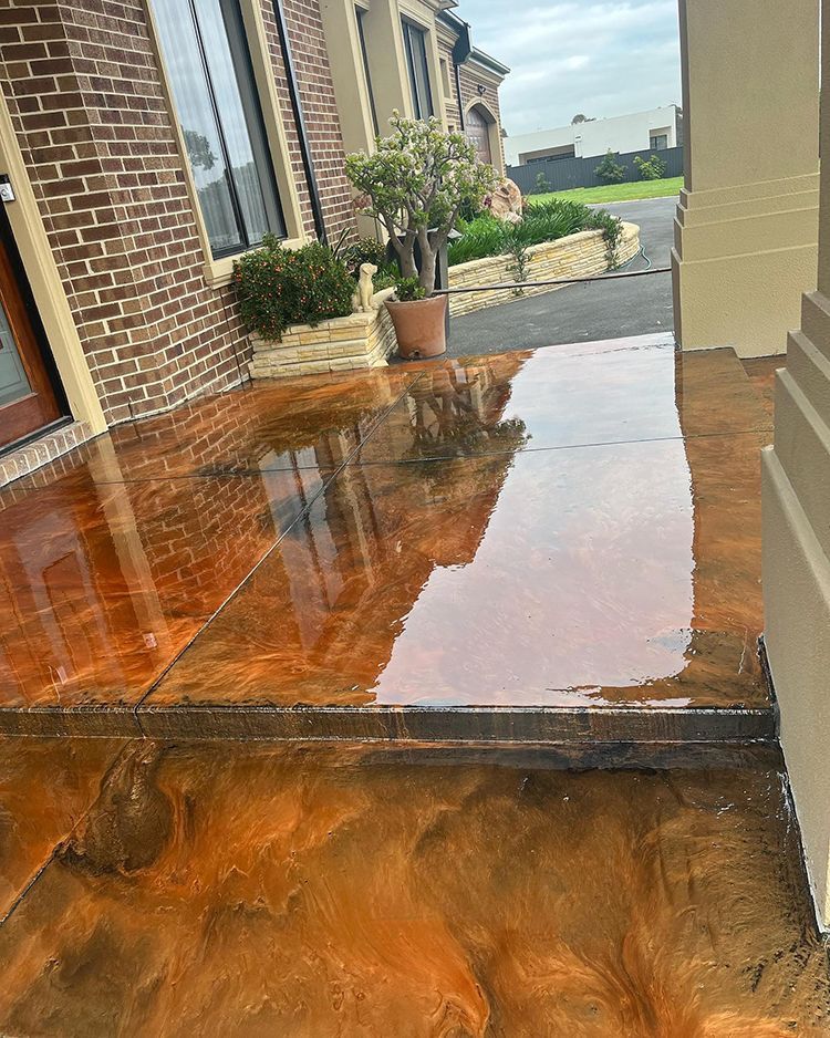 A brick building with a concrete floor in front of it