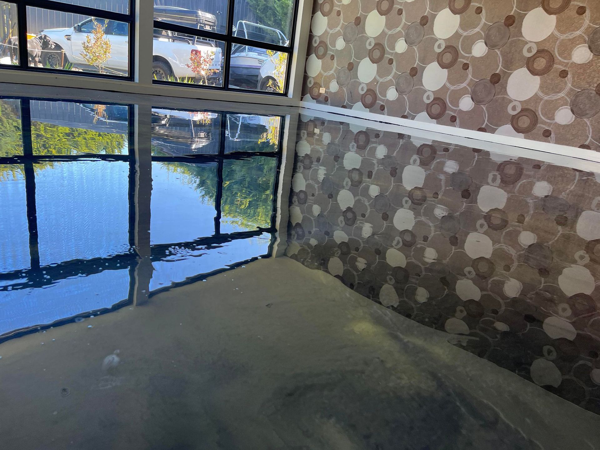 A room with a shiny black floor and a door