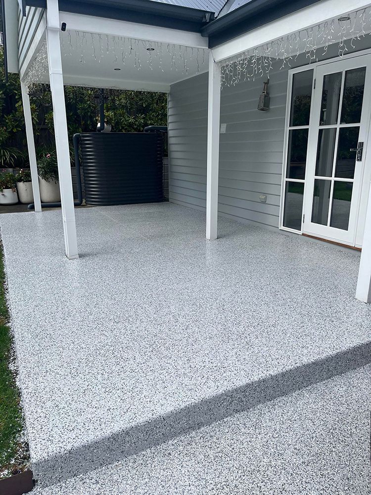 A white house with a covered patio and a white door