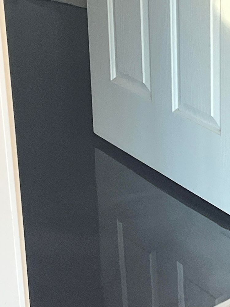 A white door with a black floor in front of it
