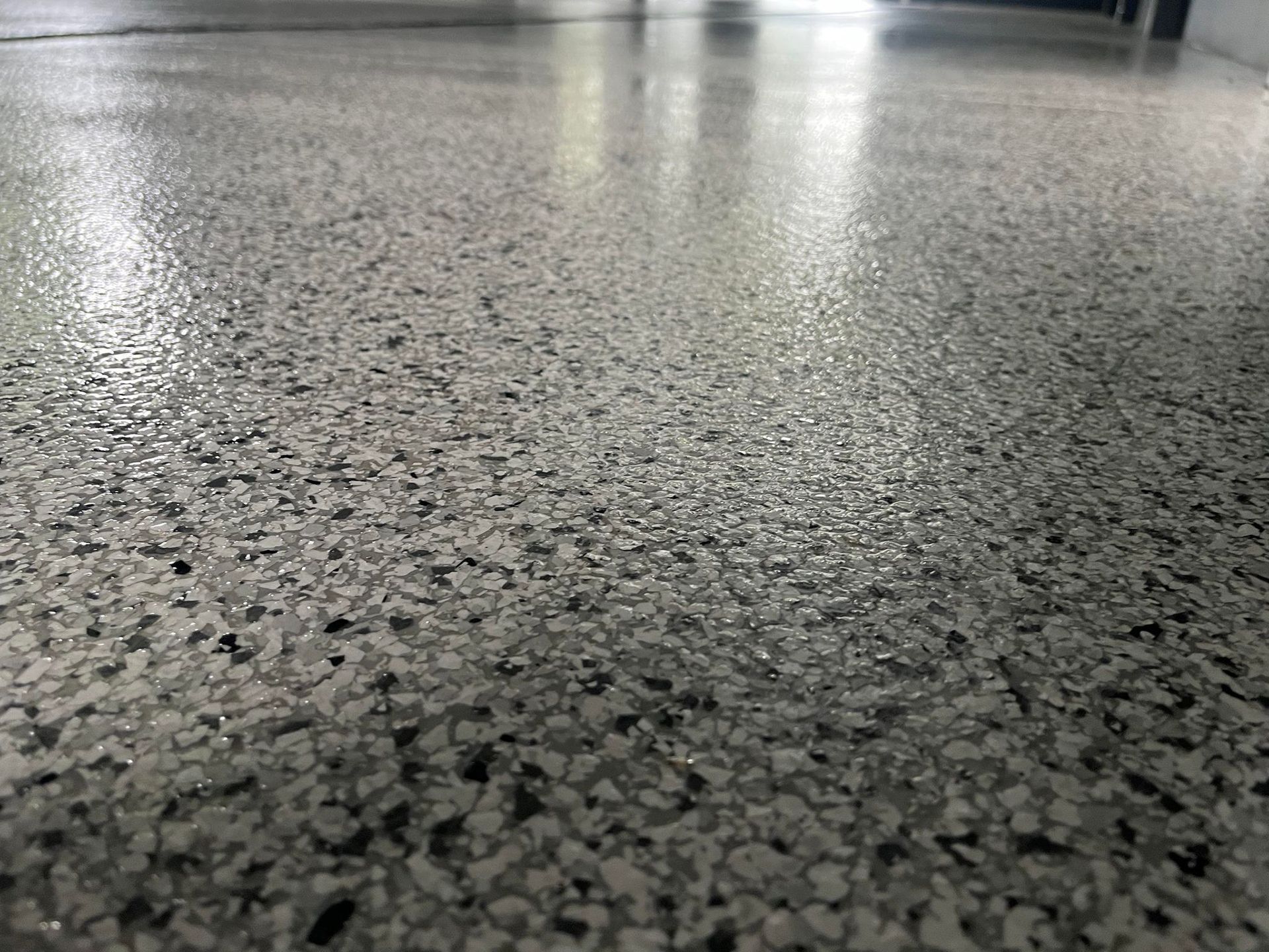 A close up of a concrete floor with a lot of small stones on it
