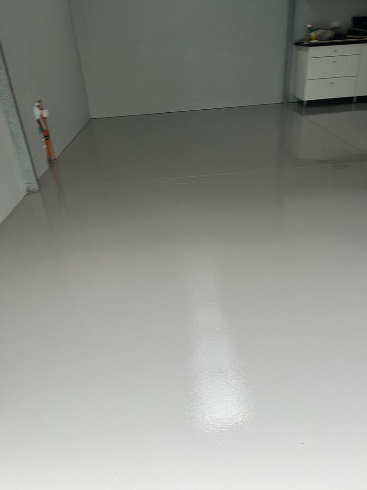 A room with a gray floor and white walls