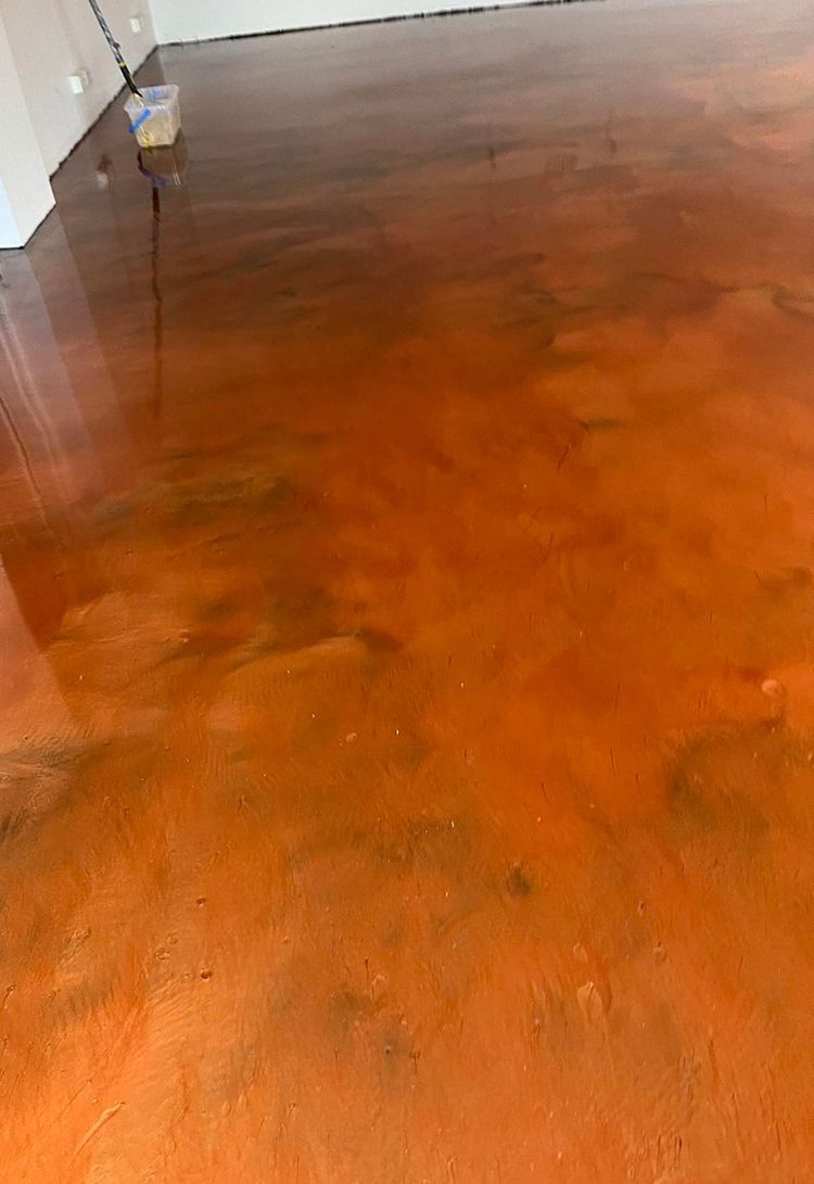 A close up of a stained concrete floor in a room