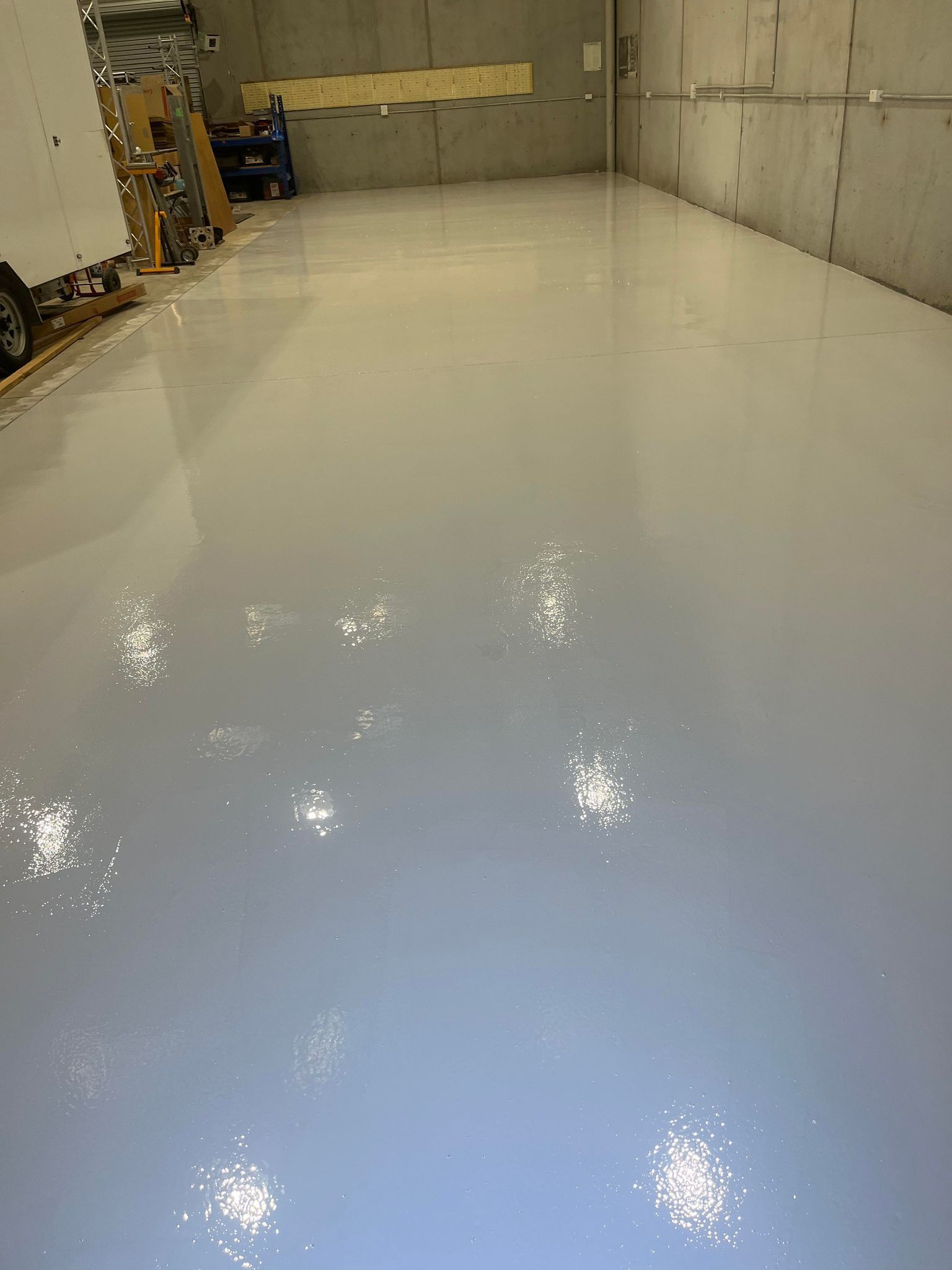 A large room with a white floor and a lot of lights on it