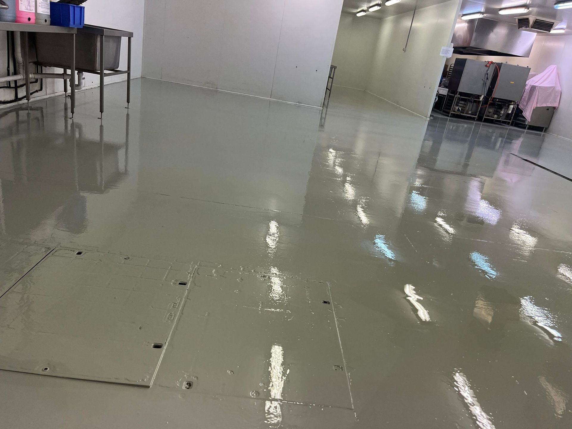 A kitchen with a shiny floor and a sink