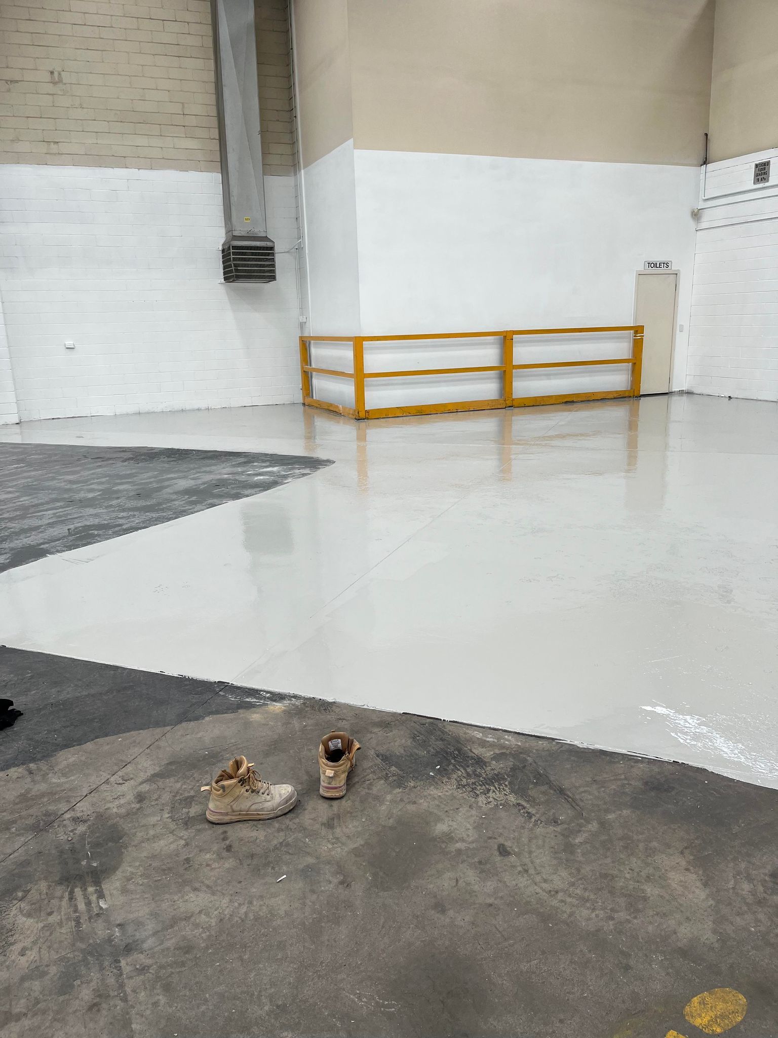 A pair of shoes are sitting on the floor of a building