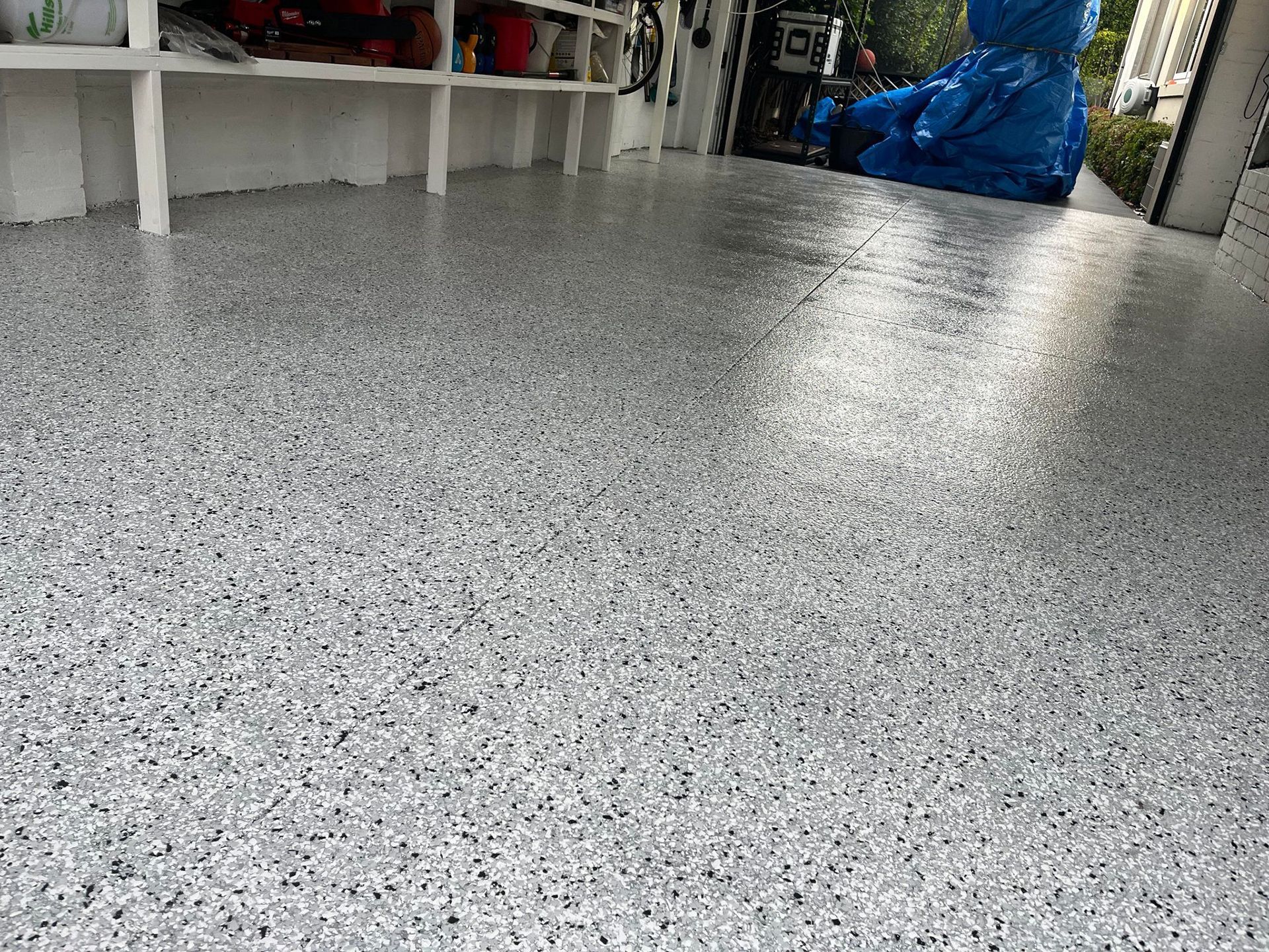 A garage floor with a cookie monster statue in the background