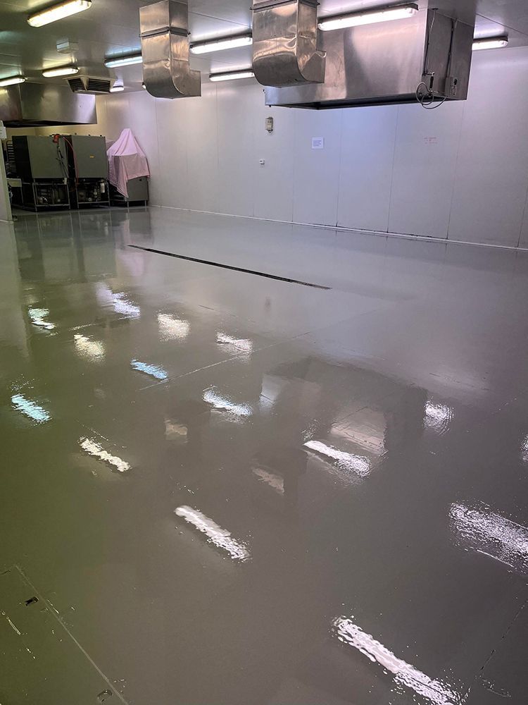 A large room with a shiny floor and a lot of lights on the ceiling