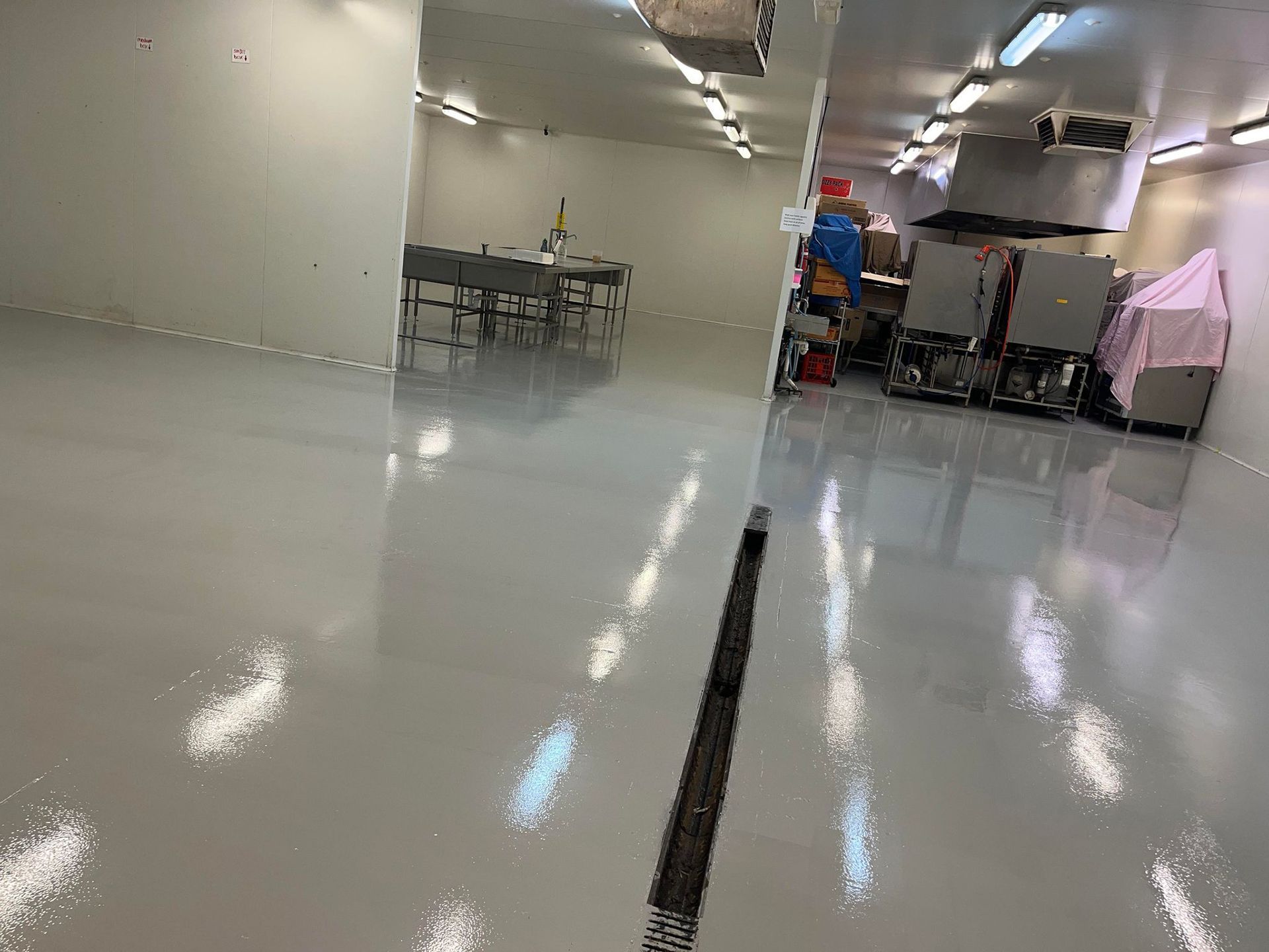 A large room with a shiny floor and white walls