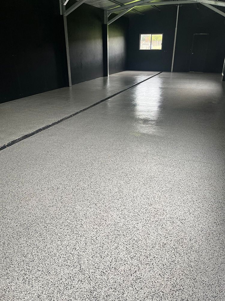 A close up of a gray surface with white and black glitter