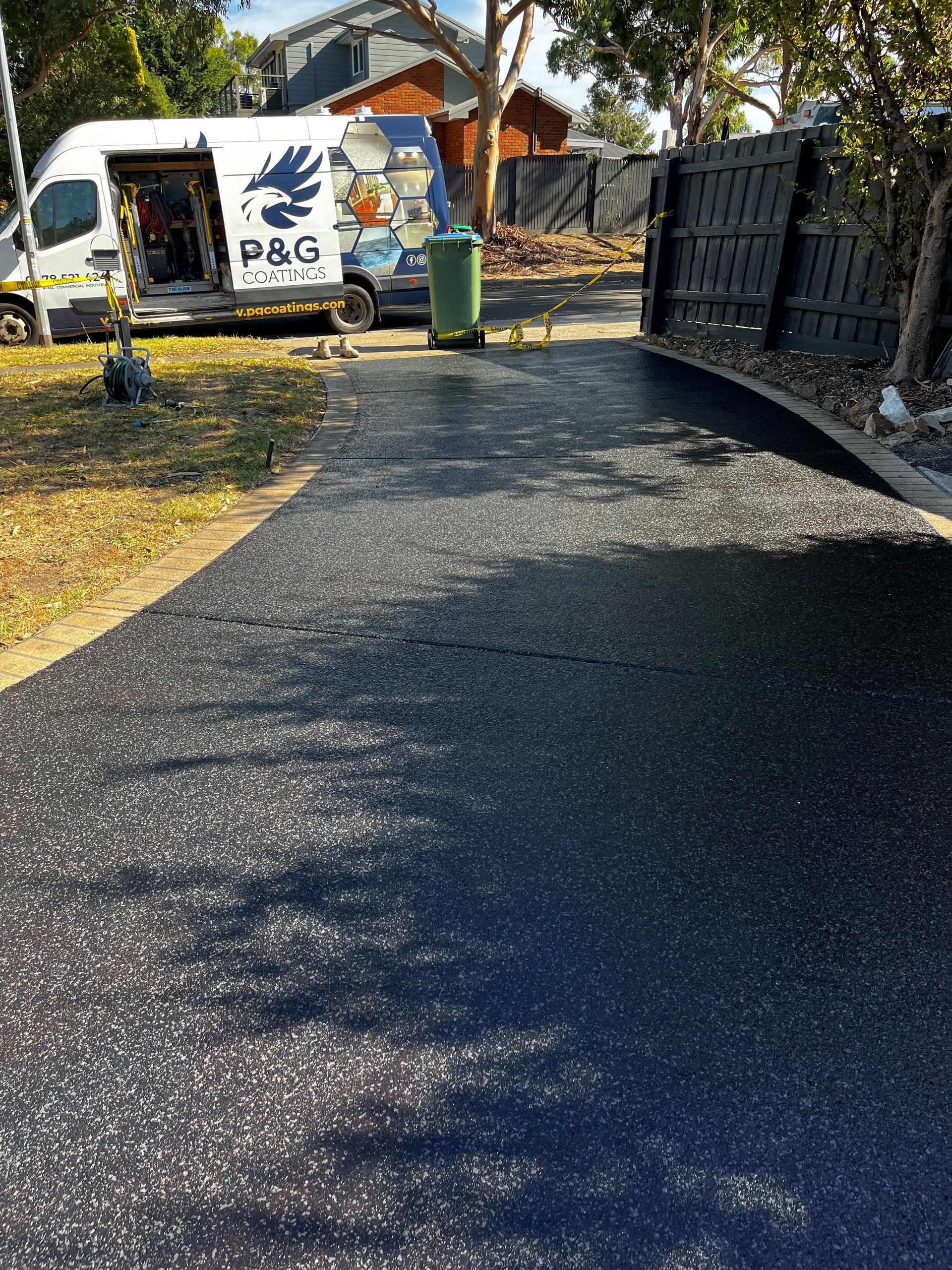A garage with a gray floor and a drain