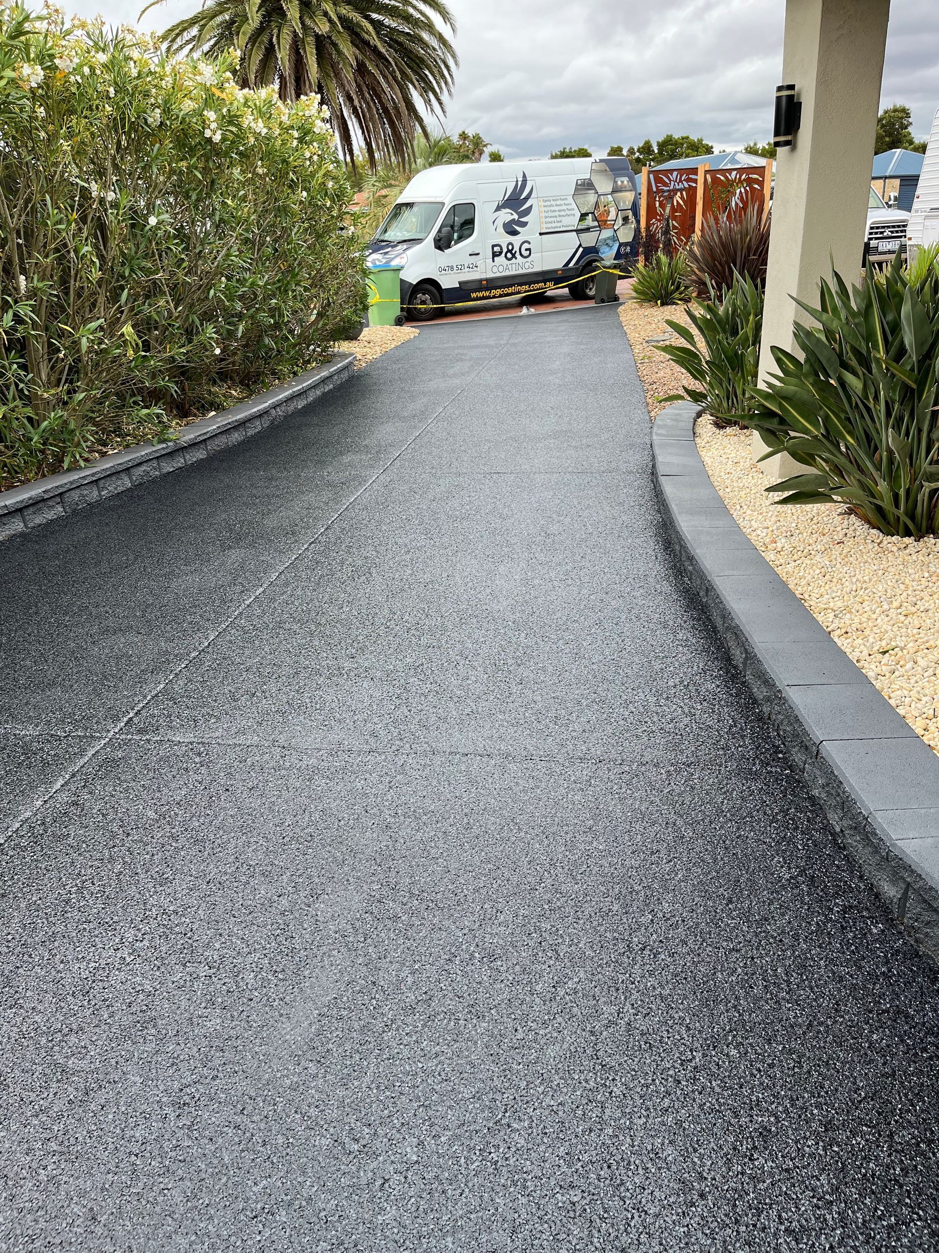 A white van is parked on the side of a road