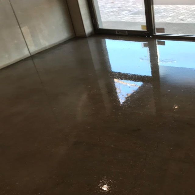 There is a reflection of a door in the floor of a room
