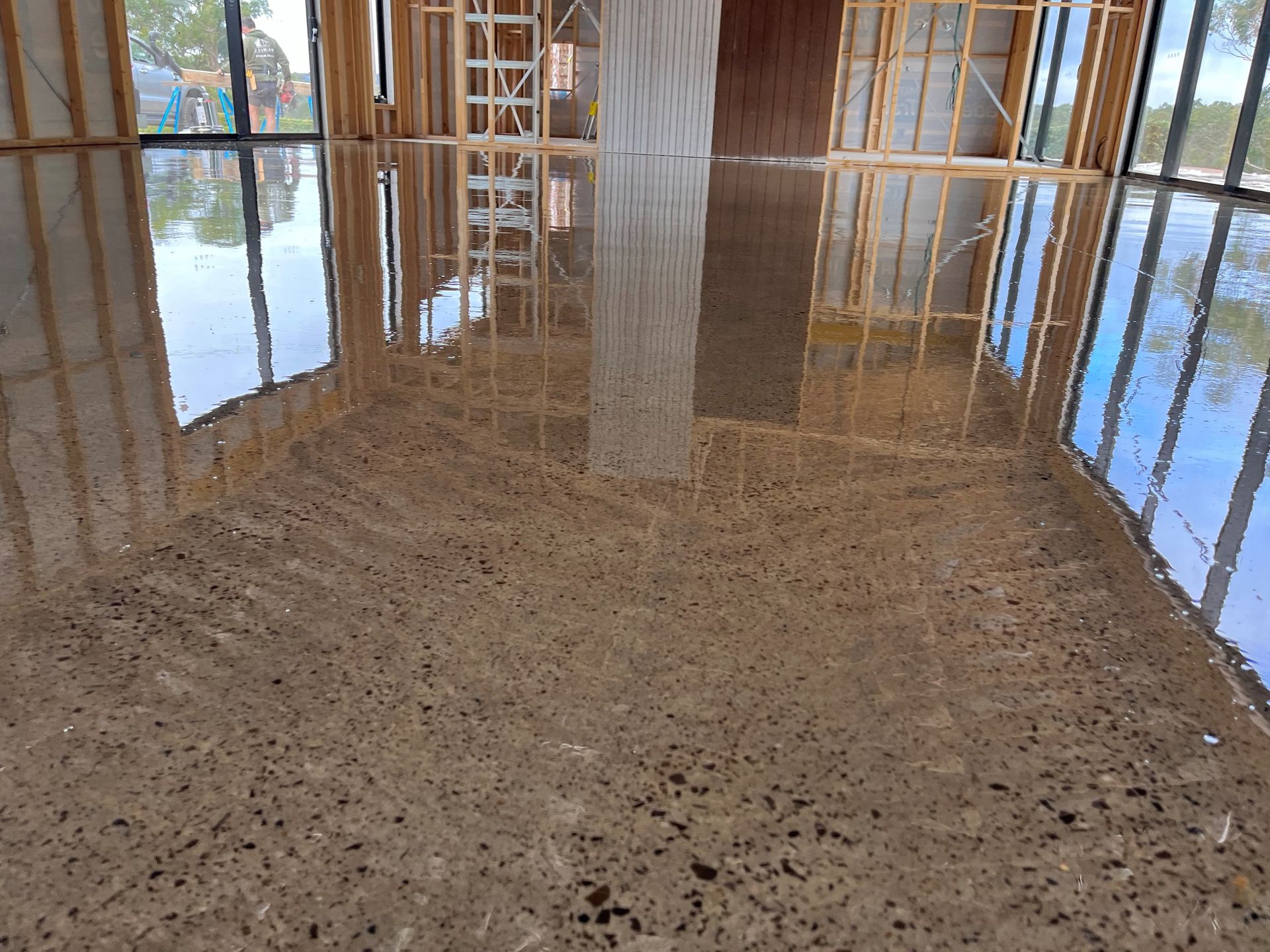 A person is using a trowel on a concrete surface