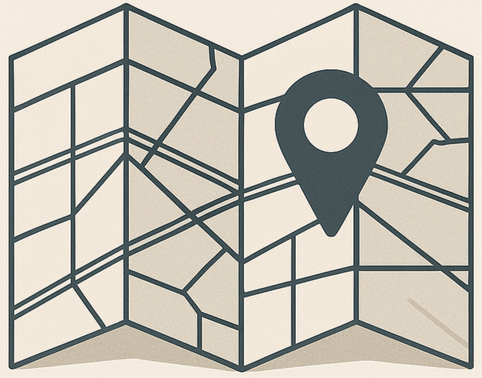 Folded map with a dark gray location marker.