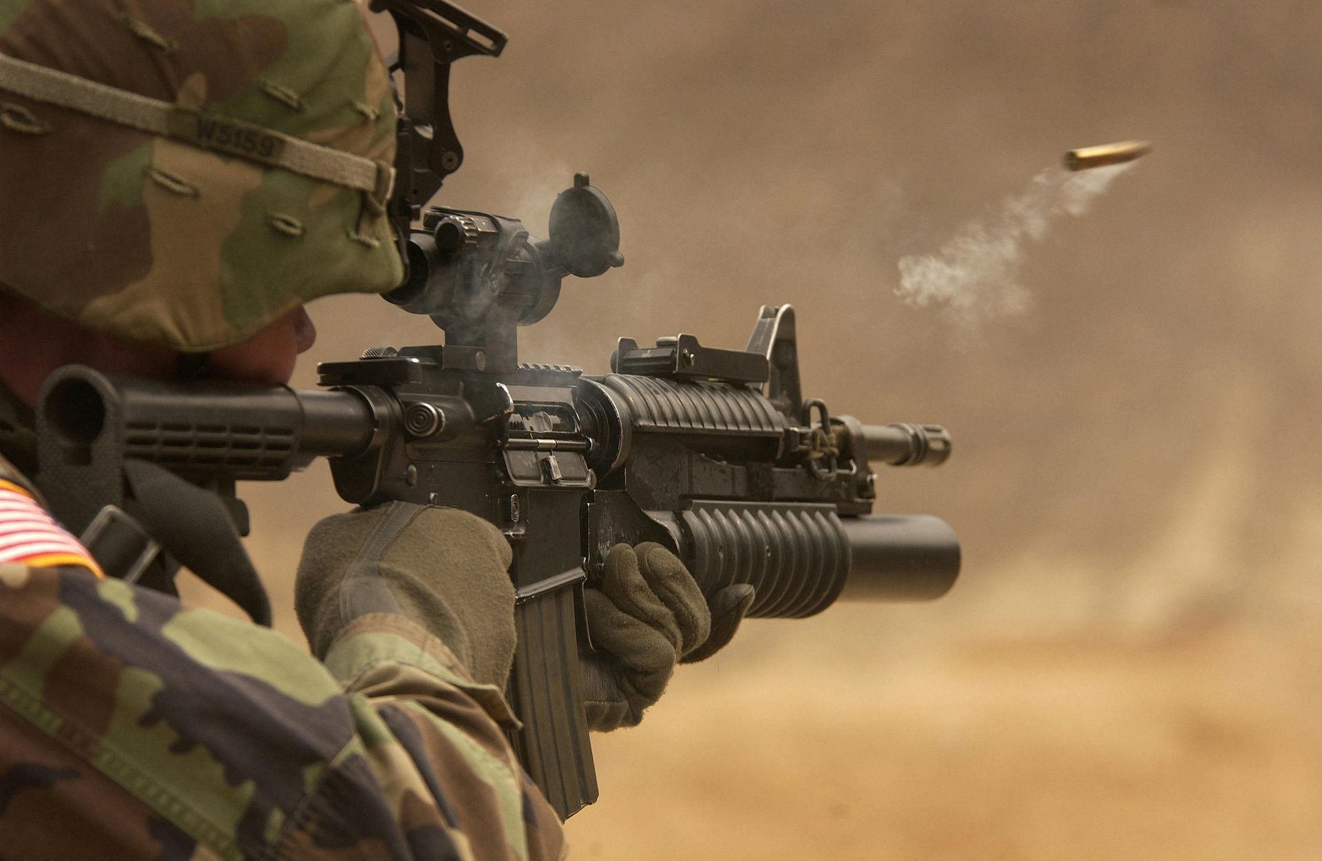 troop firing a round from his m4 rifle as the casing is ejected
