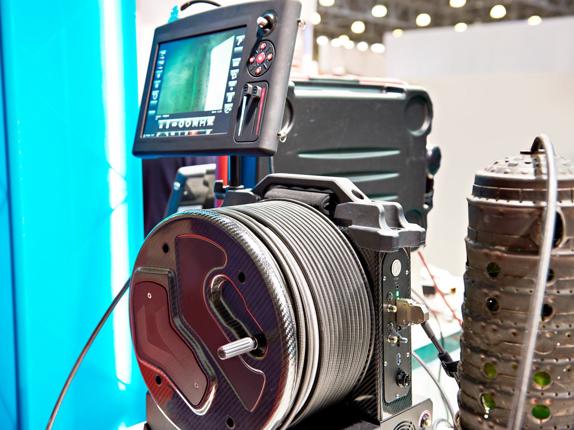 A camera with a screen attached to it is sitting on a table.