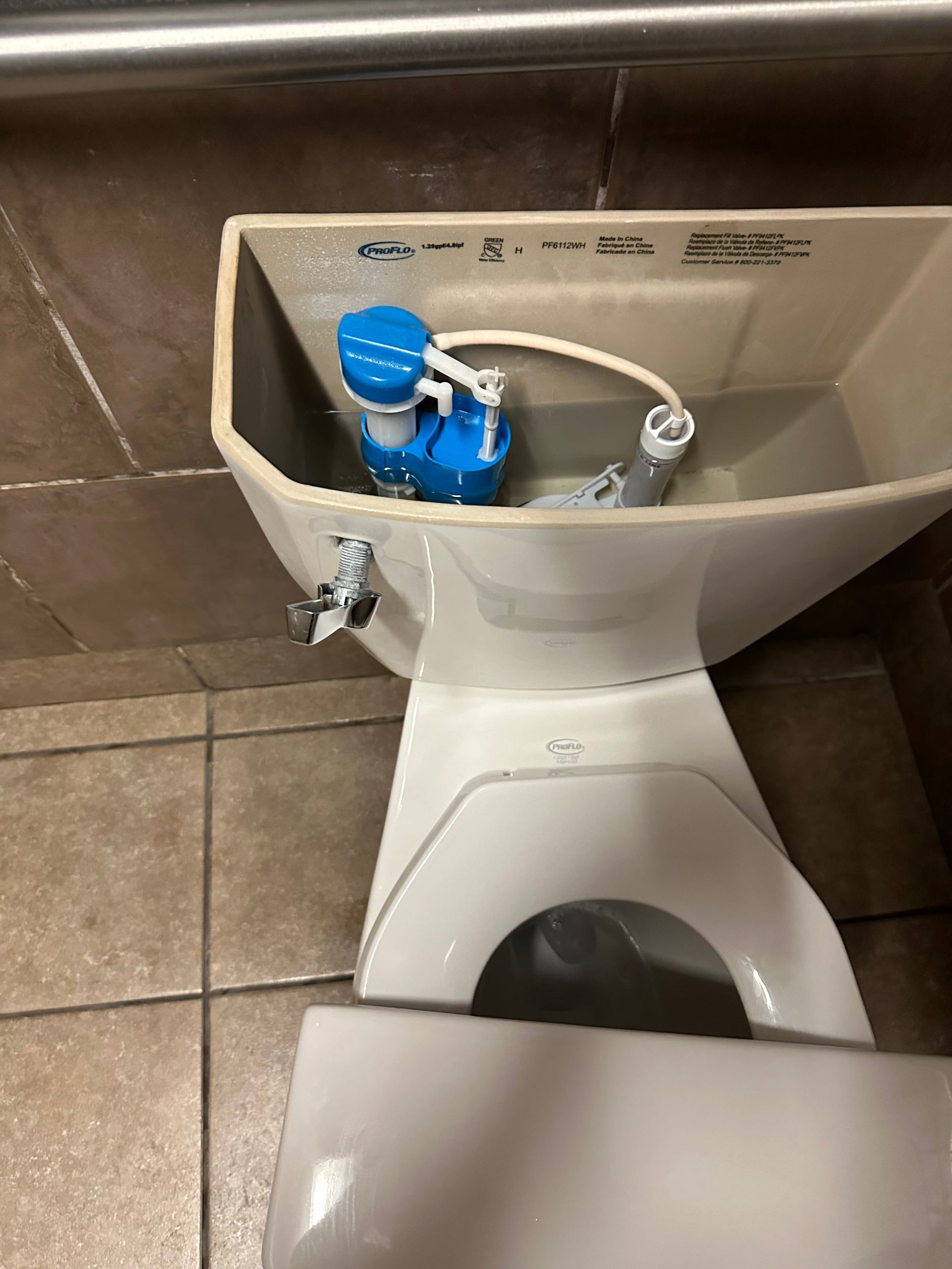A toilet with a blue tank and a white seat