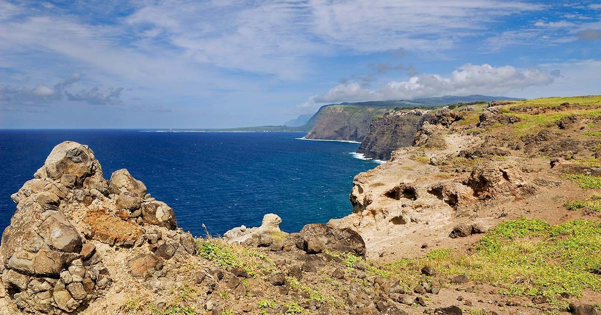 The remote Kalaupapa Peninsula on Molokaʻi, site of the historic leper colony, surrounded by dramatic sea cliffs and the Pacific Ocean.