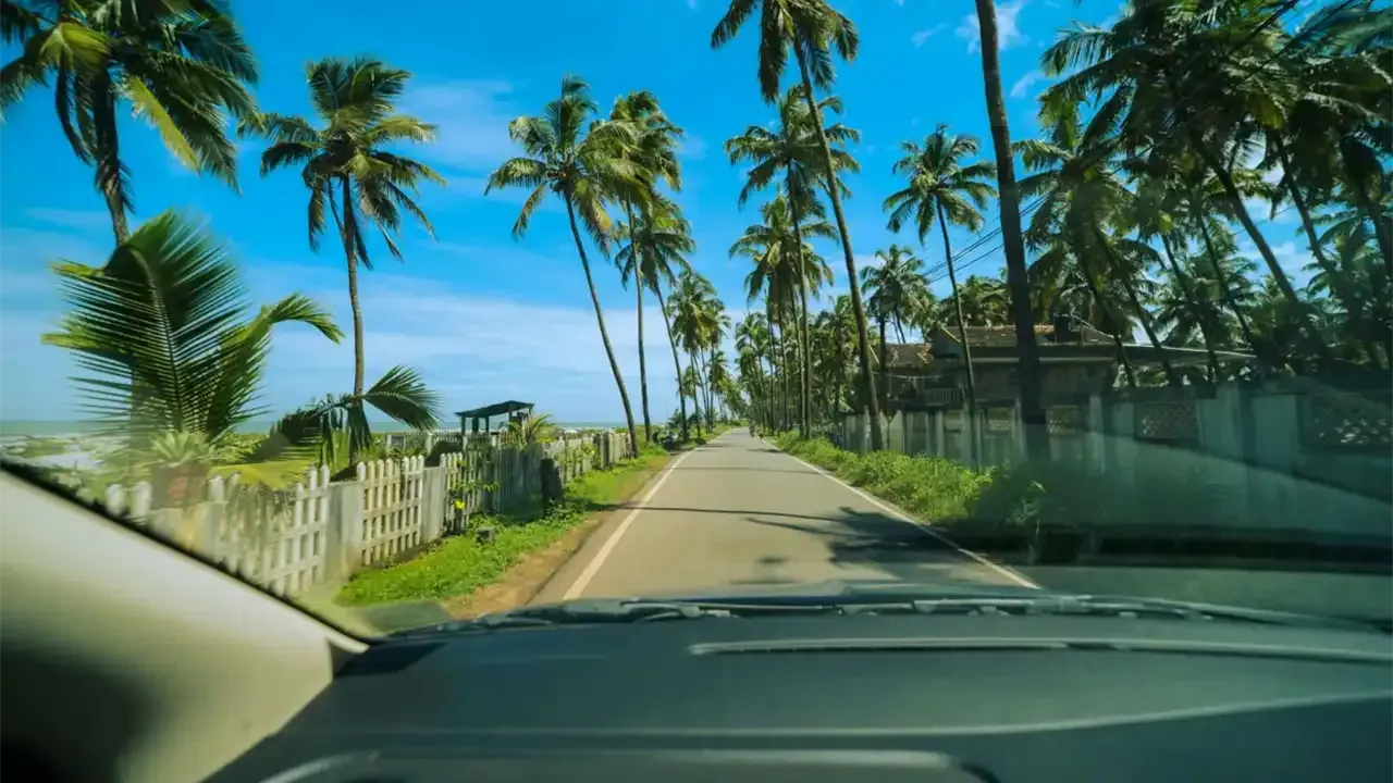 driving down a one way road on the coastline of hawaii with a view of the ocean and neighborhood
