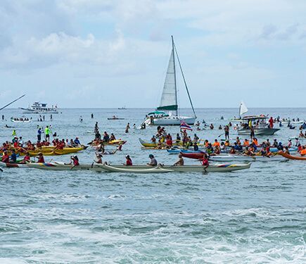 A fleet of canoes, boats and SUPers awaited Hokulea