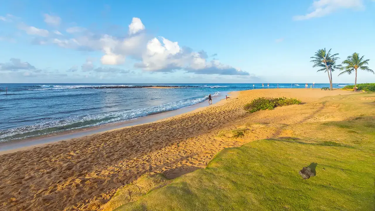 Poipu Beach, a family-friendly sandy beach on the island of Kauai, Hawaii.