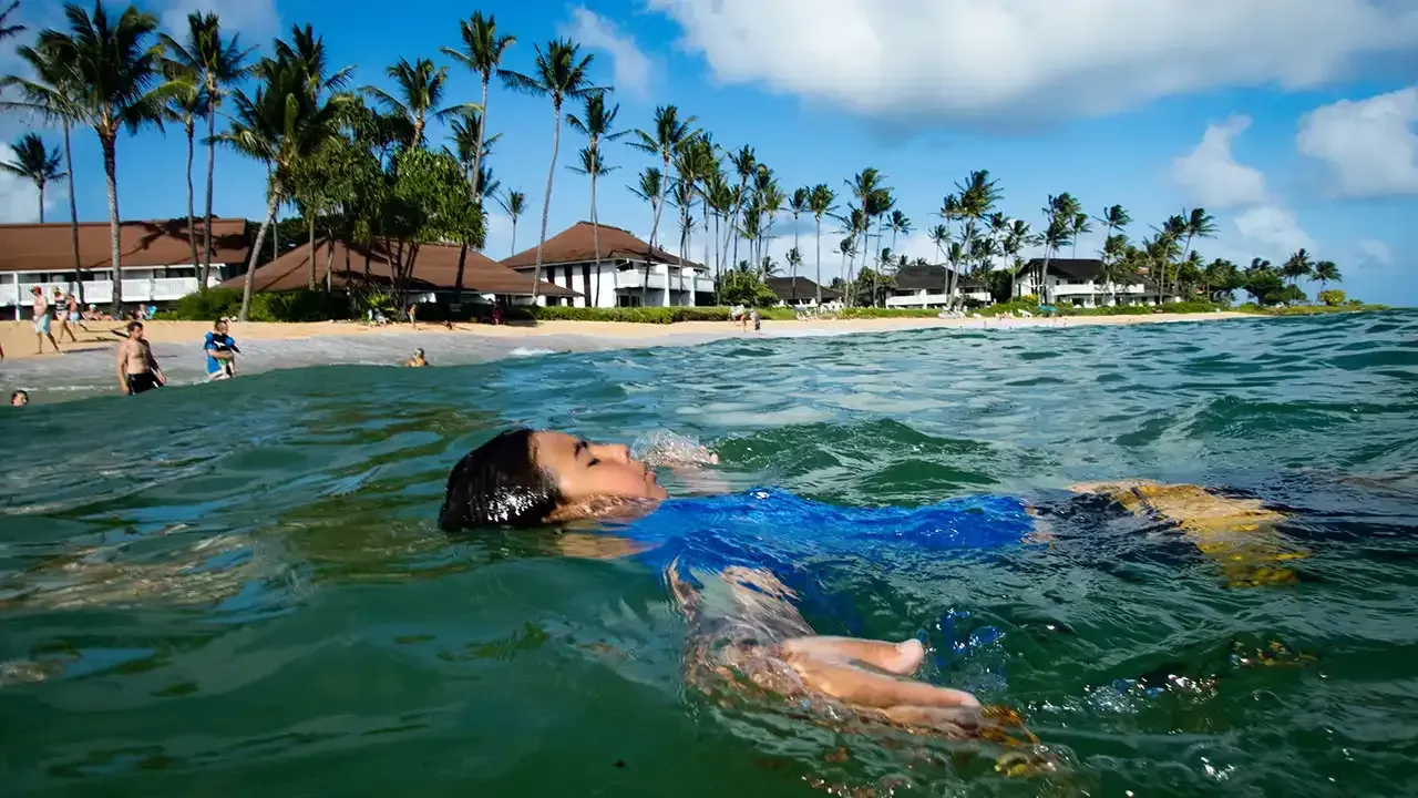 Swimming is a popular outdoor activity at Poipu Beach on the island of Kauai, Hawaii.